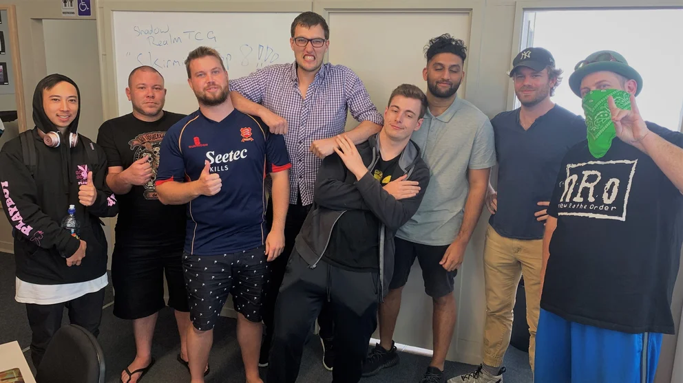 A photo of Shadowrealm Whangarei&#x27;s Top 8 Players for their Skirmish event, making thumbs up or peace signs for the camera